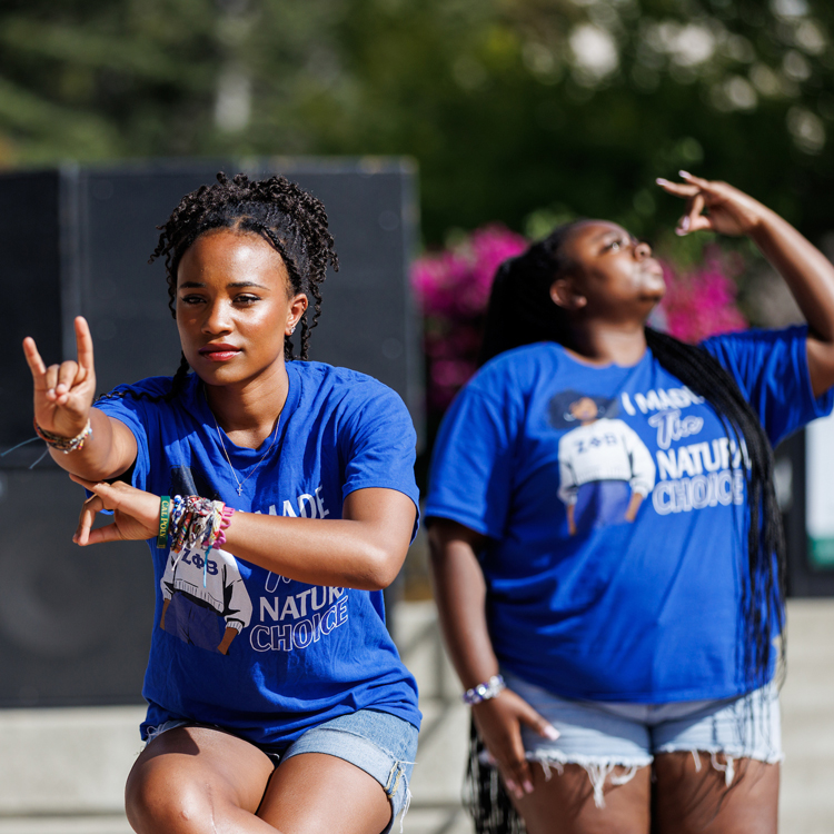 Two people in blue shirts dancing