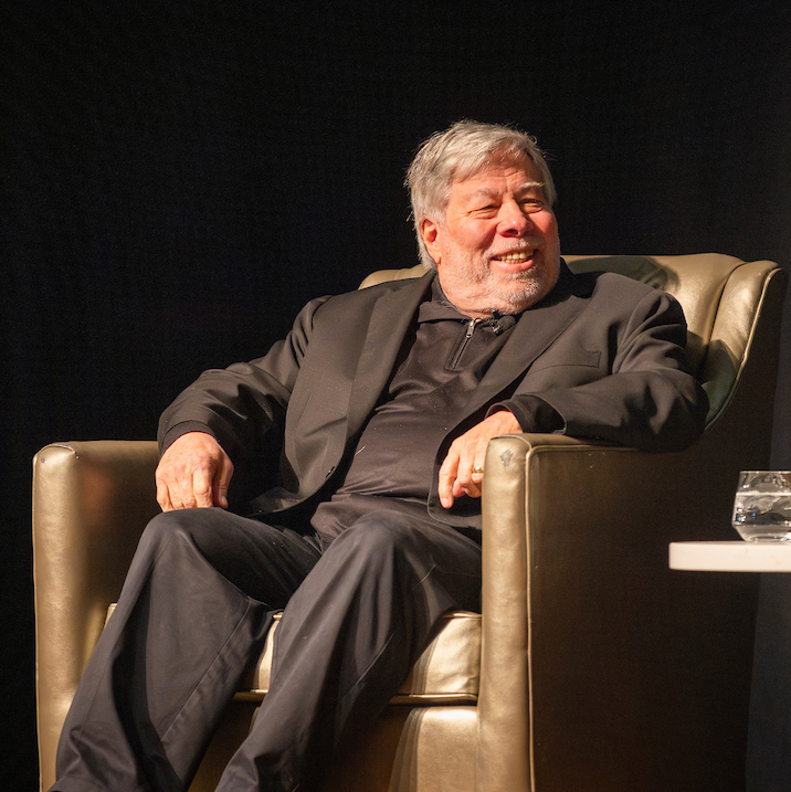 Apple co-founder Steve Wozniak sits in a chair on stage