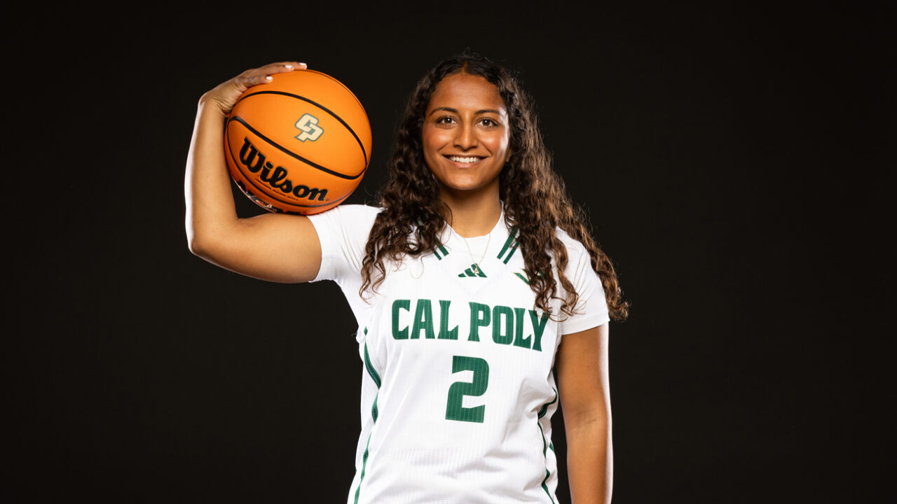 Annika Shah smiles while holding a basketball