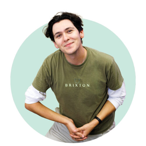 Luke Mendoza smiles while wearing a green shirt