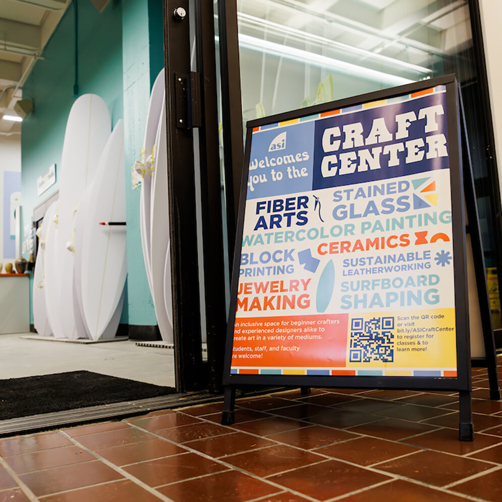 A sandwich board reading "ASI Welcomes you to the Craft Center" and a list of a variety of craft projects