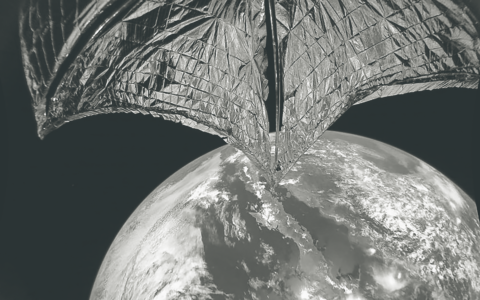 A LightSail with Earth in the background.