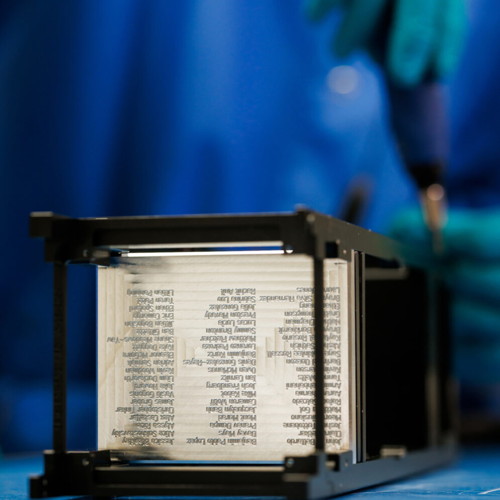 The counterweight of a CubeSat engraved with the names of dozens of students