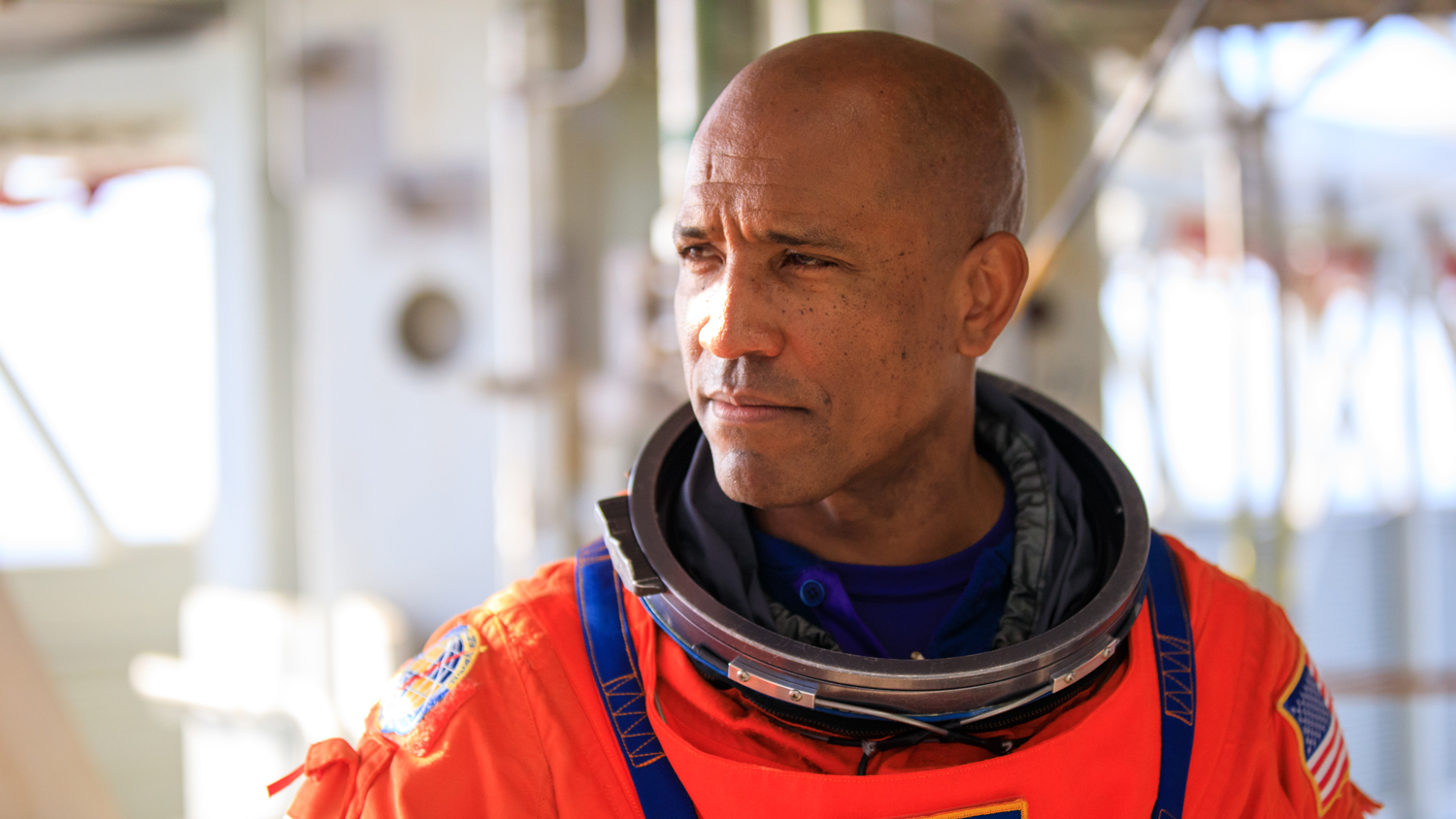 Victor Glover in an orange space suit