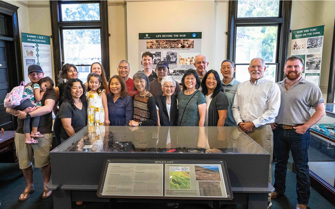 The Yoshida Family and the Cal Poly ANT 310 class standing by the exhibit.