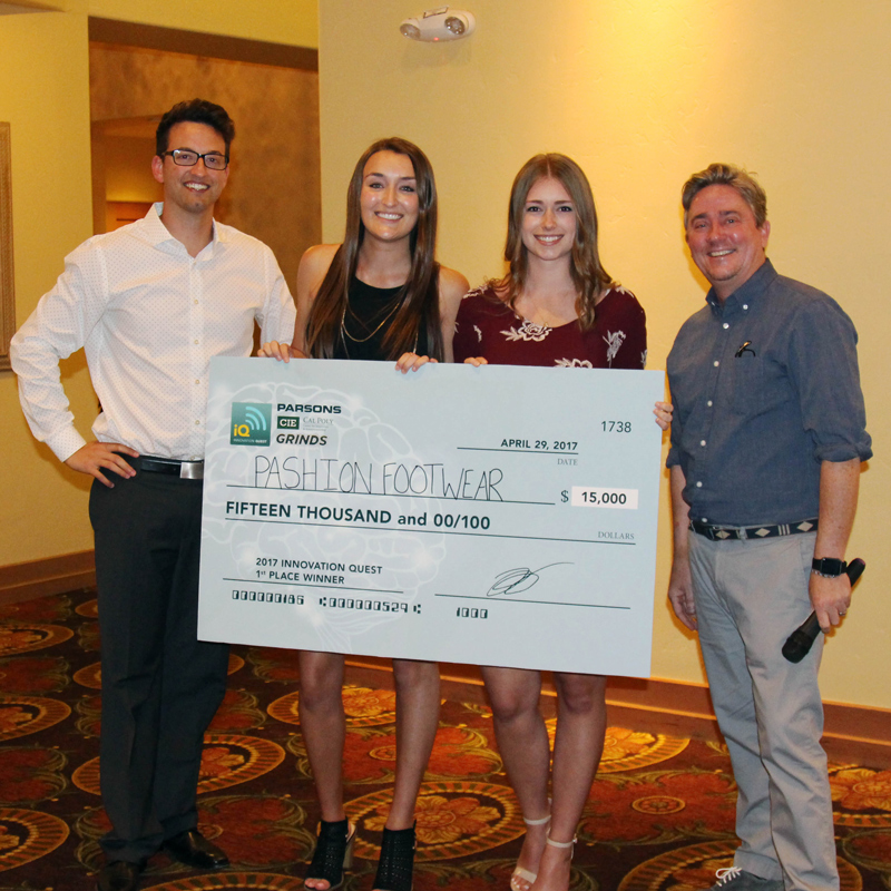 Members of Pashion Footwear hold an oversized check after winning an Innovation Quest event