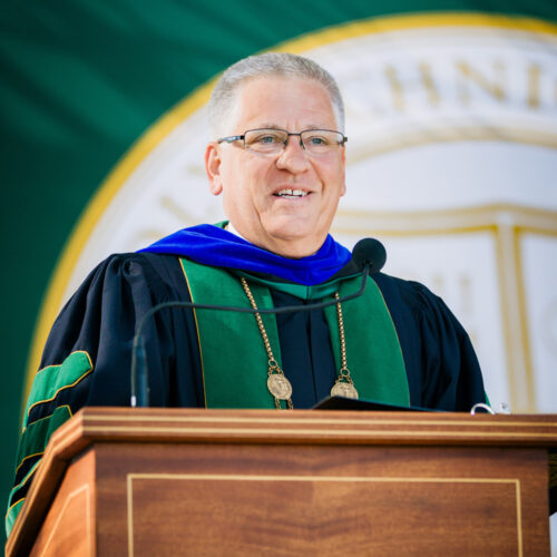 President Jeffrey D. Armstrong in academic regalia speaking at a commencement event