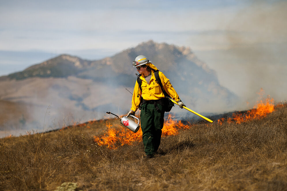 A student participating in a controlled burn in San Luis Obispo.