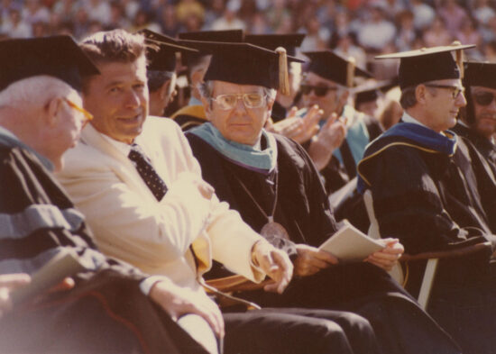 Ronald Regan speaking to faculty at a commencement ceremony.