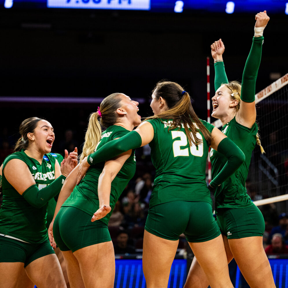 Cal Poly Volleyball players celebrate on the court