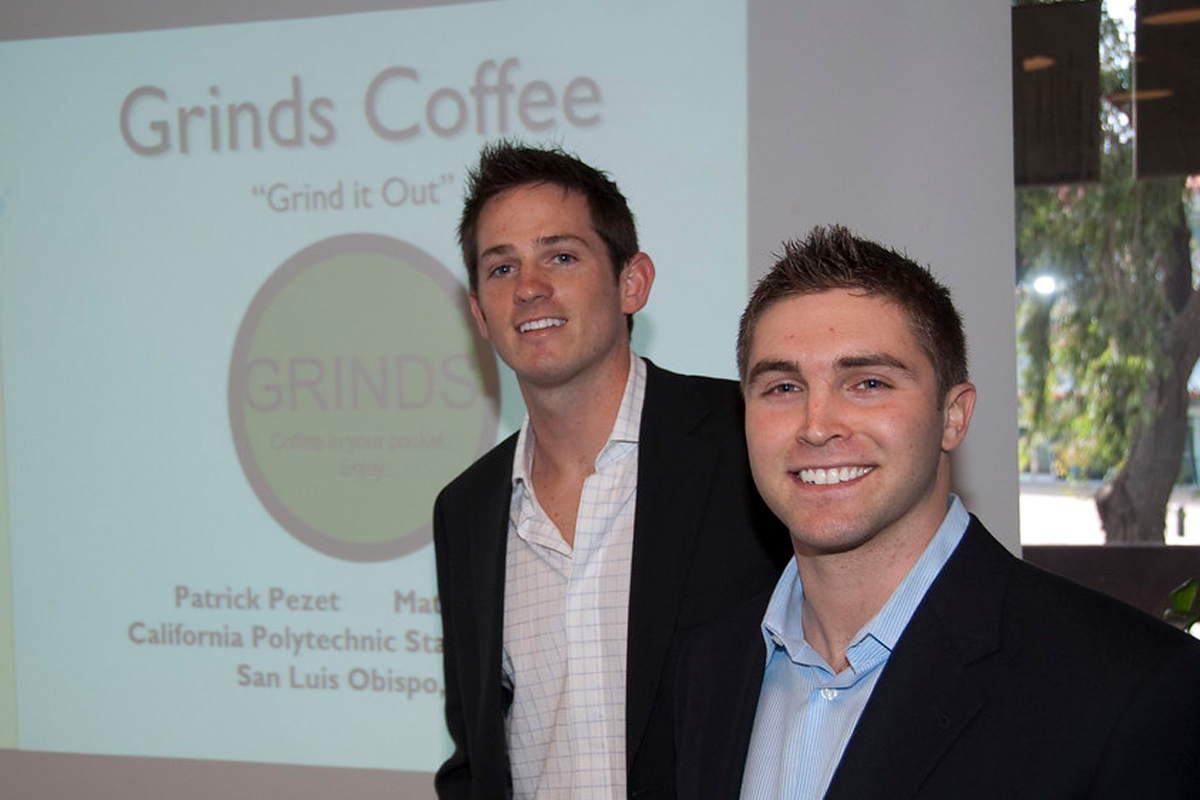 Matthew Canepa and Patrick Pezet standing give a presentation on Grinds Pouches in the early days of the startup