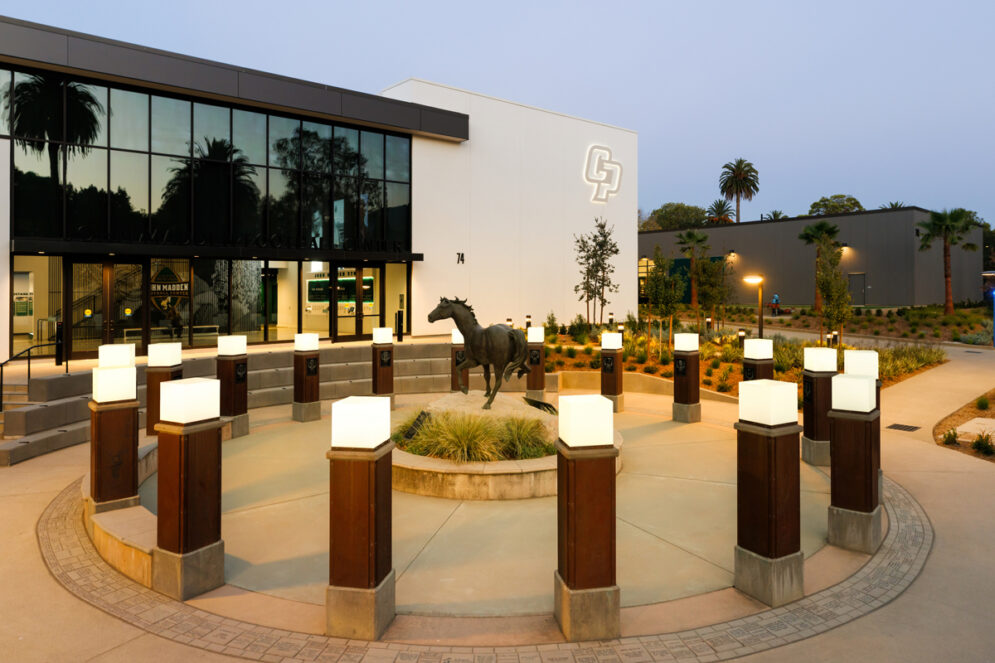 The memorial for the 1960 Cal Poly Football outside the Madden Center featuring a mustang statue and lights.