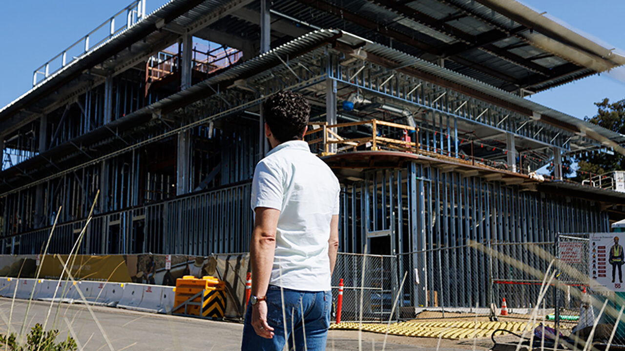 A man walks past a construction site