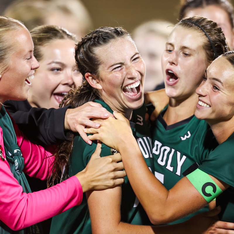 Members of the Cal Poly women's soccer team embrace after a victory